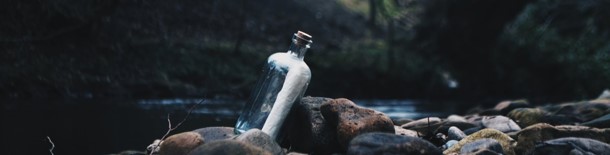 Message in a bottle, cropped photo by Andrew Measham on Unsplash